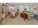 Spacious living and dining area featuring neutral carpet, a chandelier, and comfortable furnishings at 4831 Summertree Rd, Venice, FL 34293