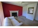 Cozy living room features a classic fireplace with tile surround and a comfortable striped couch for relaxation at 505 Duke Rd, Venice, FL 34293