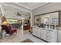 Spacious living room featuring neutral walls, tile flooring, and views of the backyard at 511 Wexford Dr, Venice, FL 34293