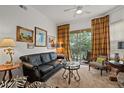 Comfortable living room featuring a black leather couch and elegant decor at 5134 Northridge Rd # 303, Sarasota, FL 34238