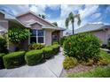 This home includes pruned hedges, flowering bushes, and well-maintained walkways at 519 Catalina Isles Cir, Venice, FL 34292