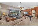 Comfortable living room with a cozy seating area, a television, and sliding glass doors to the backyard pool at 5818 Harrison Rd, Venice, FL 34293