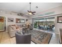 Spacious living room featuring a large sliding glass door with views of the inviting backyard pool area at 5818 Harrison Rd, Venice, FL 34293