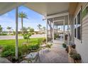 Inviting outdoor space, with green chairs, leading to a screened-in porch of a well maintained home at 614 N Waterway, Venice, FL 34285