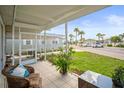 Comfortable screened porch showcasing a cozy chair and table, creating a relaxing outdoor living space at 614 N Waterway, Venice, FL 34285