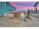 Coastal home with a covered carport and modern design elements at 616 S Casey Key Rd, Nokomis, FL 34275