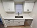 Stylish kitchen showcasing a stainless steel dishwasher and clean white cabinets with modern hardware at 7201 Daiquiri Ln, Tampa, FL 33634