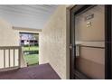 Exterior of unit 204 with views of the pond and landscaping from the front porch entry way at 756 White Pine Tree Rd # 204, Venice, FL 34285