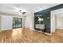 Bright and open living room with sliding door to balcony and contemporary ceiling fan and lighting at 756 White Pine Tree Rd # 204, Venice, FL 34285
