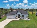 Aerial view of a well-maintained home with lush green lawn and meticulous rock garden landscaping at 9157 Genesee St, Port Charlotte, FL 33981