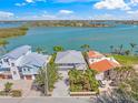 Breathtaking aerial shot of waterfront home showcasing its prime location near bay and lush tropical landscaping at 931 Inlet Cir, Venice, FL 34285