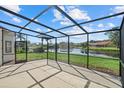 Enjoy the water view from this screened porch with a black aluminum frame at 9528 Knightsbridge Cir, Sarasota, FL 34238