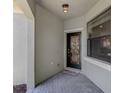 Covered front entry with decorative glass door, brick pavers, and sidelight window at 11192 Campazzo Dr, Venice, FL 34292