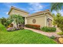 Charming home featuring a paved walkway and verdant landscaping at 11739 Okaloosa Dr, Venice, FL 34293