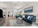 Bright and spacious living room with wood floors, modern furnishings, and an abundance of natural light at 11819 Tempest Harbor Loop, Venice, FL 34292