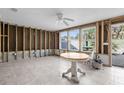 Spacious sunroom with tile flooring, ceiling fan, and bright windows offering lots of natural light and beautiful outdoor views at 1350 Holiday Dr, Englewood, FL 34223