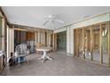 Bright sunroom featuring tile flooring, a ceiling fan, and open walls offering potential for personalized renovation at 1350 Holiday Dr, Englewood, FL 34223
