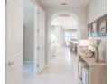 Inviting hallway with tile flooring leads to the open living spaces at 13871 Miranese St, Venice, FL 34293