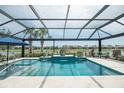 Gorgeous screened-in pool and spa with lake view and spacious deck area at 13871 Miranese St, Venice, FL 34293