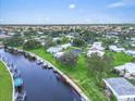 This aerial shot showcases a waterfront property with a 40-foot dock, beautiful landscaping, and tranquil views at 16 Oakwood N Dr # 16, Englewood, FL 34223