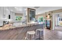 Stylish kitchen featuring a stone countertop bar with seating, complemented by modern cabinetry and stainless steel appliances at 16 Oakwood N Dr # 16, Englewood, FL 34223
