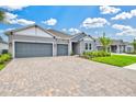 Attractive exterior showcasing a three-car garage, well-maintained lawn, and inviting curb appeal at 1607 Laurel Brook Ln, Port Charlotte, FL 33953