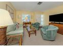 Cozy living room with neutral carpet, matching furniture, and modern entertainment setup at 168 The Corso # 168, Venice, FL 34285