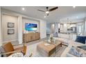 Comfortable living room with a sectional sofa, wood-style flooring, and a ceiling fan at 17873 Grand Prosperity Dr, Venice, FL 34293