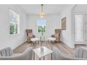 Bright living room with wood flooring, comfortable seating arrangements, and a scenic view at 2146 Snapdragon Ln, Venice, FL 34292