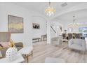 Open-concept living space with modern furniture, wood flooring, and plenty of natural light at 2146 Snapdragon Ln, Venice, FL 34292