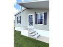 Close up view of the front porch and door with white railings at 217 Blackburn Blvd, North Port, FL 34287