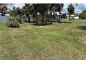Expansive backyard with lush green grass and privacy fence, ideal for outdoor activities at 232 Fiesole St, Venice, FL 34285