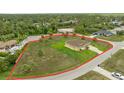 Aerial view of single-Gathering home and large property outlined in red at 2479 Grandview Dr, North Port, FL 34288
