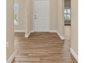 Inviting foyer with beautiful wood-look tile flooring and a view to the front door at 2479 Grandview Dr, North Port, FL 34288