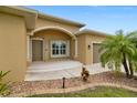 Charming front porch with concrete steps and walkway with mature tropical landscaping at 2479 Grandview Dr, North Port, FL 34288