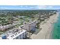 Scenic aerial view of the beachfront condo, pool, beach, and surrounding neighborhood at 255 The Esplanade N # 106, Venice, FL 34285