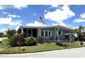 Charming single-story home featuring a screened in porch and well-maintained lawn with mature landscaping at 344 Mariner Dr, North Port, FL 34287