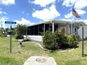 Charming single-story home featuring a screened in porch and well-maintained lawn with mature landscaping at 344 Mariner Dr, North Port, FL 34287