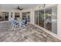 Covered patio with beautiful stone flooring and patio table, perfect for outdoor entertaining at 346 Roseling Cir, Venice, FL 34293