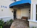 Entrance to the condo features bench seating, a covered entryway and a well-maintained facade at 3730 Cadbury Cir # 703, Venice, FL 34293