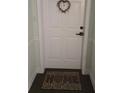 A welcoming white front door with a decorative wreath and a 'HOME' doormat at 3730 Cadbury Cir # 703, Venice, FL 34293