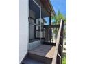Screened porch with dark trim on second floor with stairs leading up to a light textured condo at 3862 59Th W Ave # 4180, Bradenton, FL 34210