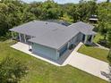 Birds eye view of single story home with gray roof, driveway, and well-maintained yard at 3863 Albin Ave, North Port, FL 34286