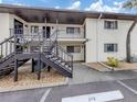 Building exterior with stairs leading to upper units and parking space, showcases practical design and accessibility at 401 Airport E Ave # 304, Venice, FL 34285