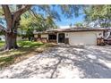 Well-maintained single-story home with attached garage and spacious driveway at 4227 Blossom Rd, Venice, FL 34293