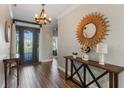 Inviting foyer with a decorative mirror, stylish console table, and a glimpse of the interior at 4260 Wordsworth Way, Venice, FL 34293