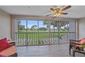 Balcony with golf course view, fan and wicker furniture to enjoy the Florida lifestyle at 437 Cerromar Ln # 414, Venice, FL 34293