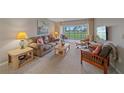 Relaxing living room with plush seating and golf course views from the screened-in lanai at 437 Cerromar Ln # 414, Venice, FL 34293