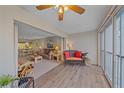 Bright living room features wood flooring, ceiling fan and large windows offering ample natural light at 437 Cerromar Ln # 414, Venice, FL 34293