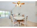 Cozy dining area featuring a round table with four chairs and a ceiling fan with light at 437 Cerromar Ln # 513, Venice, FL 34293